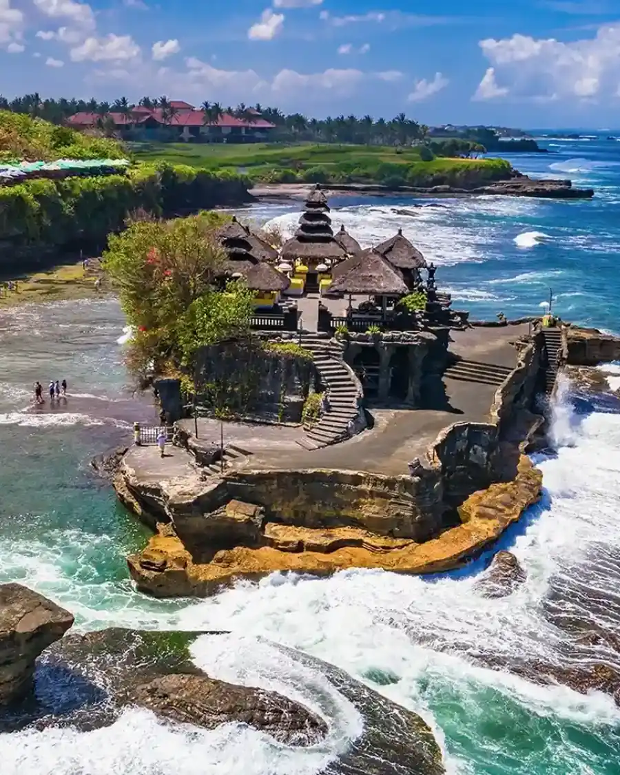 Aerial view of a Balinese sea temple on a rocky headland