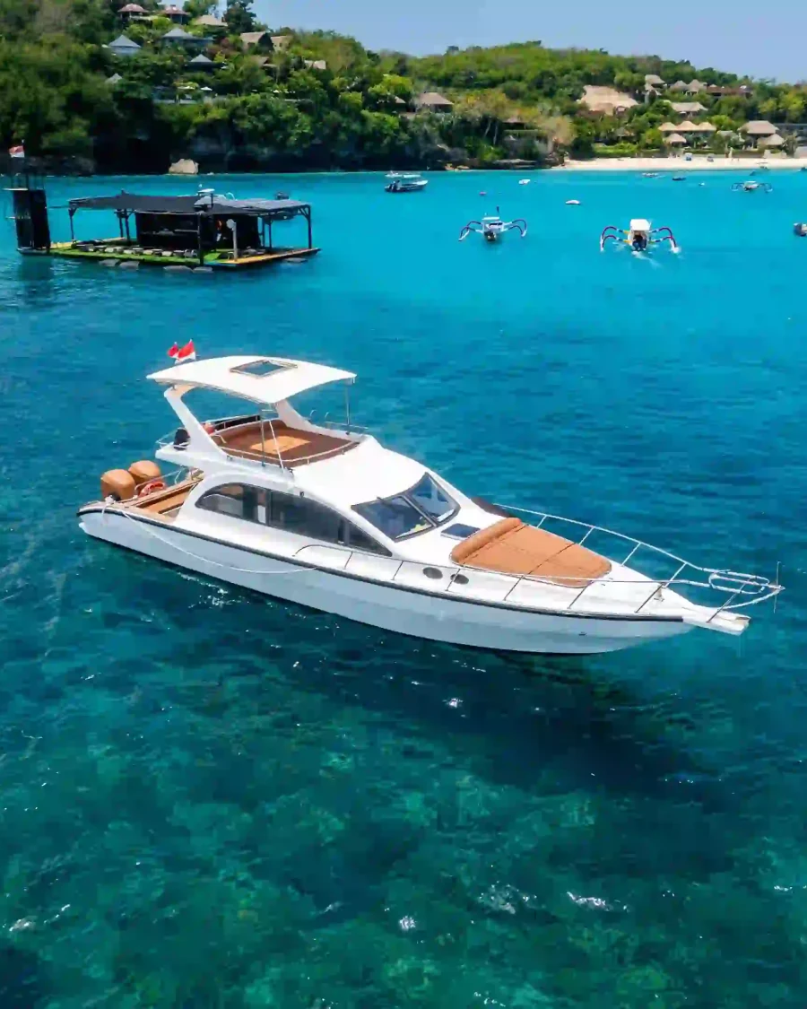 Motor yacht anchored over clear turquoise water off the Bali coast